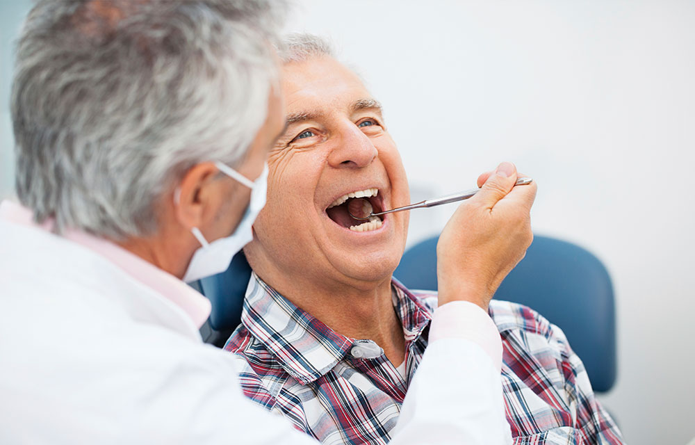 Senior man getting dental checkup