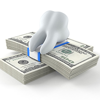Tooth sitting on pile of money