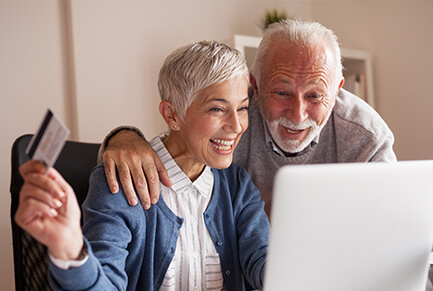 Happy Senior Couple Buying Online