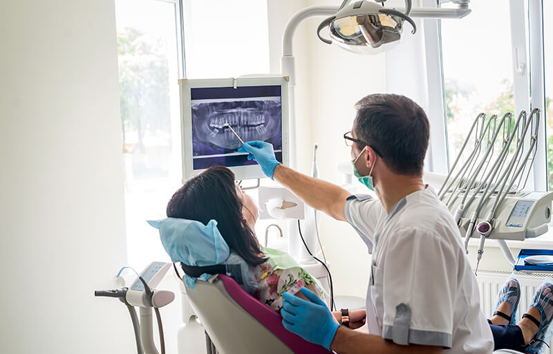Periodontist treating patient.