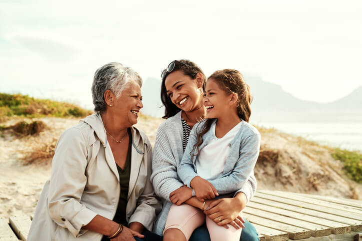 three generation of women sitting and laughing