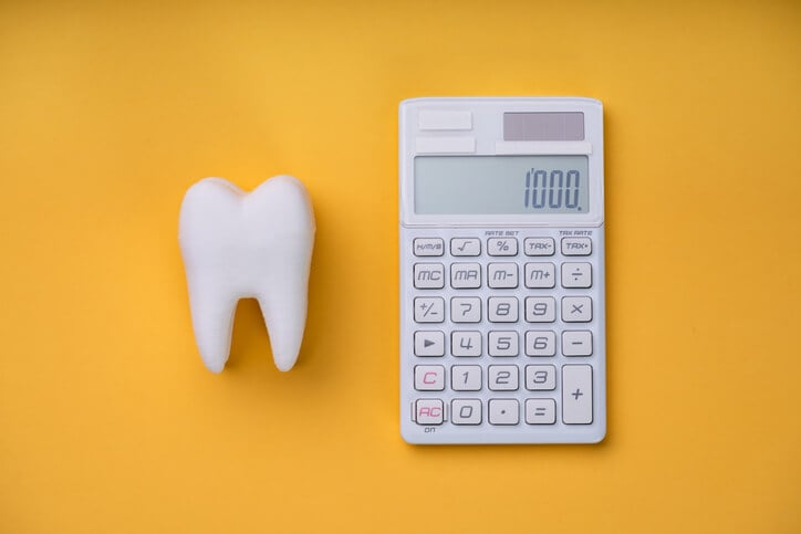 a tooth next to a calculator