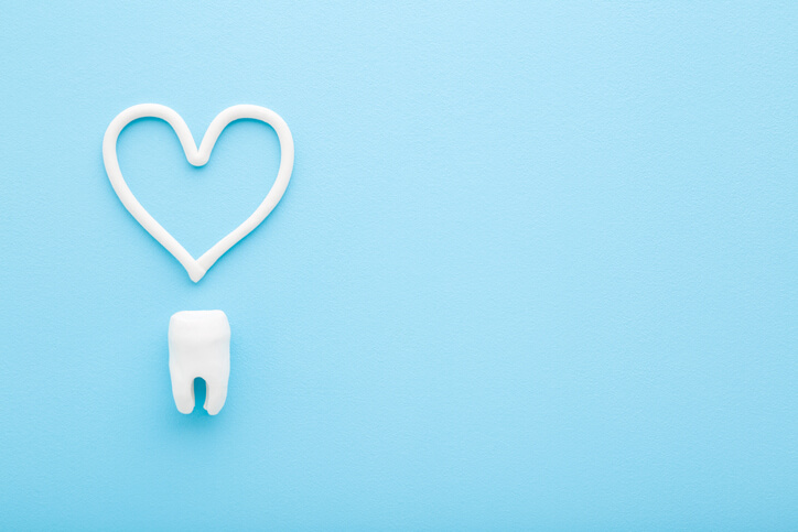 tooth with toothpaste heart