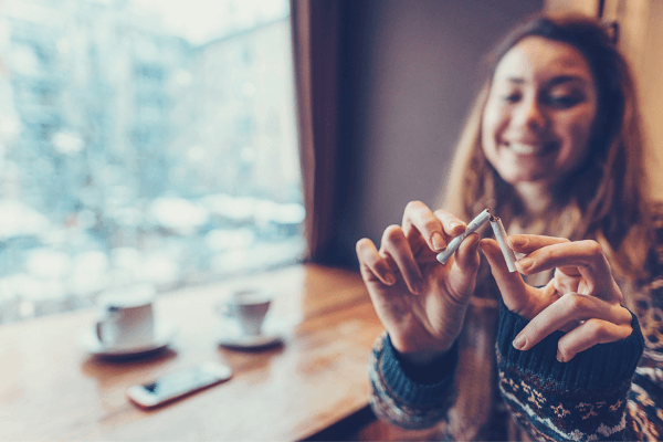 picture of woman breaking a cigarette